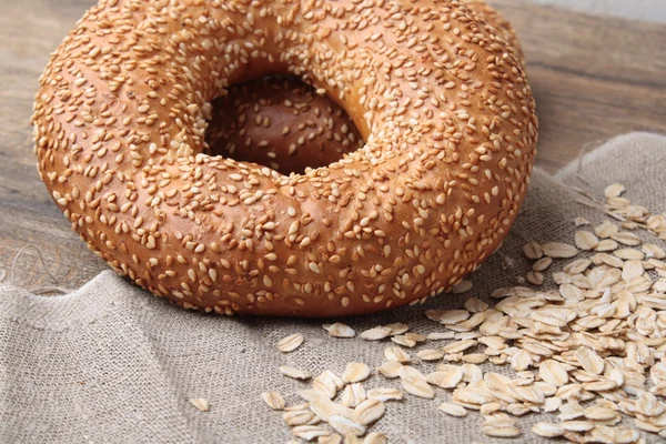 Bagel with sesame seeds and milk — Stock Photo, Image