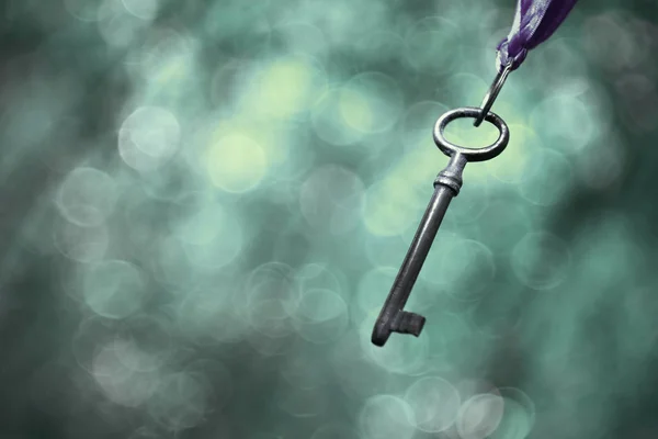 Hanging key in blue — Stock Photo, Image