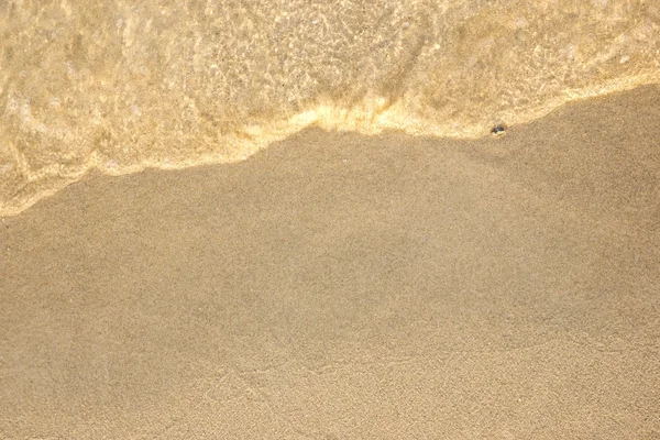 Песок и волны — стоковое фото