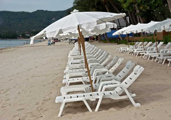 Sombrillas blancas en la playa — Foto de Stock