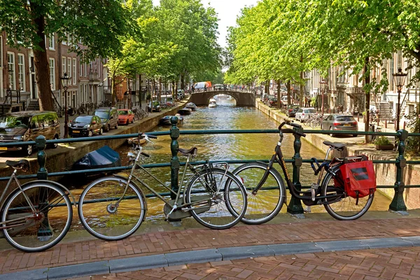 Amsterdam - cyklar på en bro över kanalen — Stockfoto