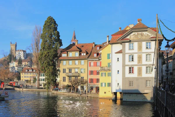 Ancient painted lodges on river bank. Lucerne, Switzerland — Stock Photo, Image