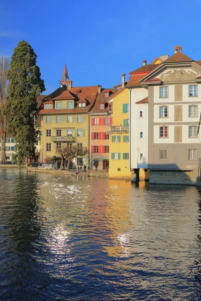 Ancient painted lodges on river bank. Lucerne, Switzerland — Stock Photo, Image