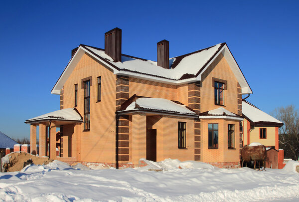 Low country construction. Two-storeyed cottage from brick