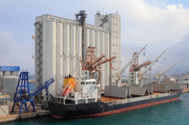 Elevator and bulk carrier with grain, seaport. Savona, Italy clipart