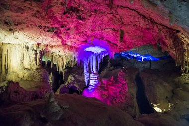 Illuminated Stalactites and stalagmites in Ngilgi cave in Yallingup clipart