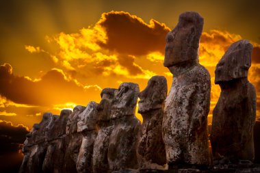 Standing moais with orange clouds in background in Easter Island clipart