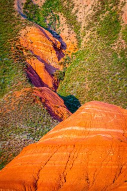 Big Bogdo mountain. Red sandstone outcrops on the slopes sacred mountain in Caspian steppe Bogdo - Baskunchak nature reserve, Astrakhan region, Russia clipart