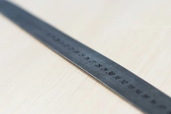 Precision measurement tool made of steel, millimeter, detail photo with low depth focus. Stainless steel ruler.