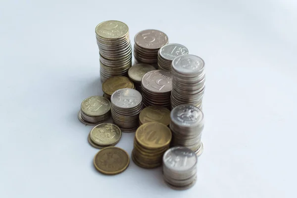 Columns of coins, piles of coins arranged on white background, business banking idea, shallow focus