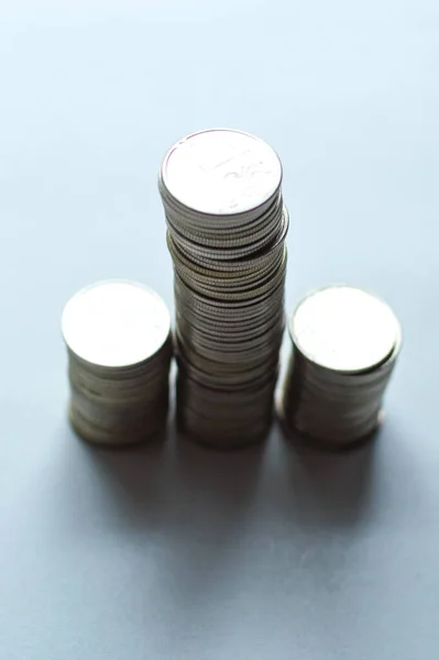 Columns of coins, piles of coins arranged on white background, business banking idea, shallow focus