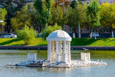 Astrakhan, Russia. The ancient pond with the name Swan Lake in center of city. clipart