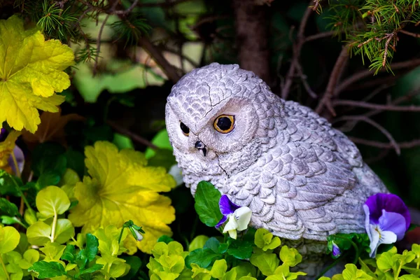 Garden decoration toy owl statue in the park.