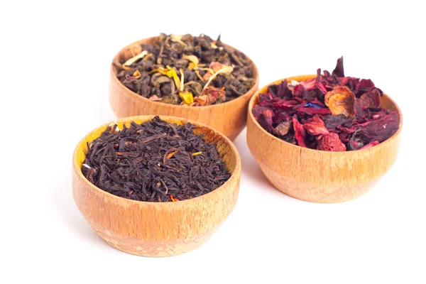 Dry tea in wooden plates, on white background. Leaves of red, green and black tea. Macro photo. — Stock Photo, Image