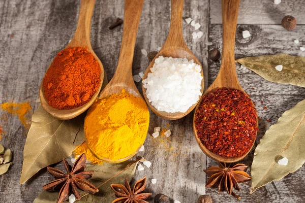 Spices. Spice in Wooden spoon. Herbs. Curry, Saffron, turmeric, cinnamon and other on a wooden rustic background. Pepper. Large collection of different spices and herbs. Salt, paprika. — Stock Photo, Image