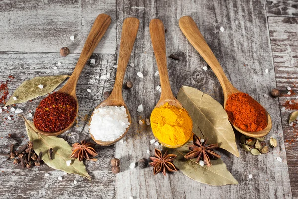 Spices. Spice in Wooden spoon. Herbs. Curry, Saffron, turmeric, cinnamon and other on a wooden rustic background. Pepper. Large collection of different spices and herbs. Salt, paprika. — Stock Photo, Image