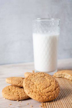 Tahta masada bir bardak sütle kurabiyeler.