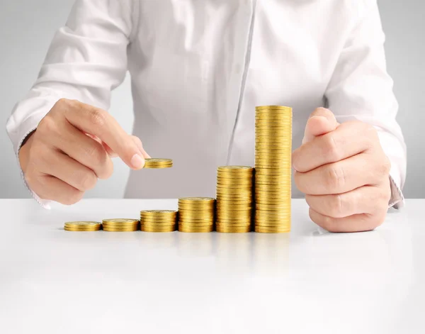 Hand human hand putting coin to mone — Stock Photo, Image