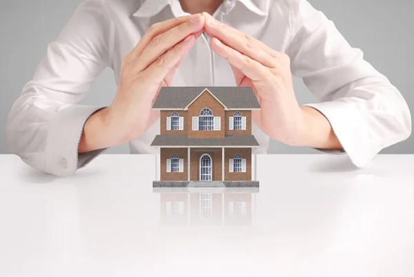 Mortgage concept by house from  hand — Stock Photo, Image