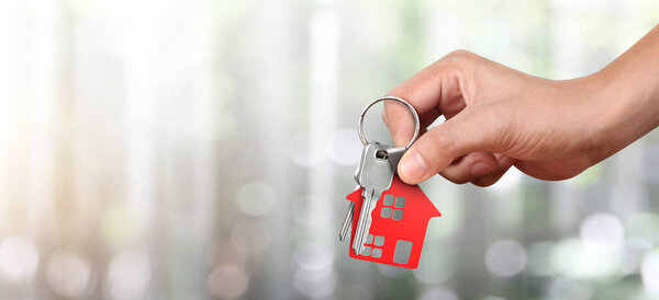 Real estate agent handing over a house keys in hand