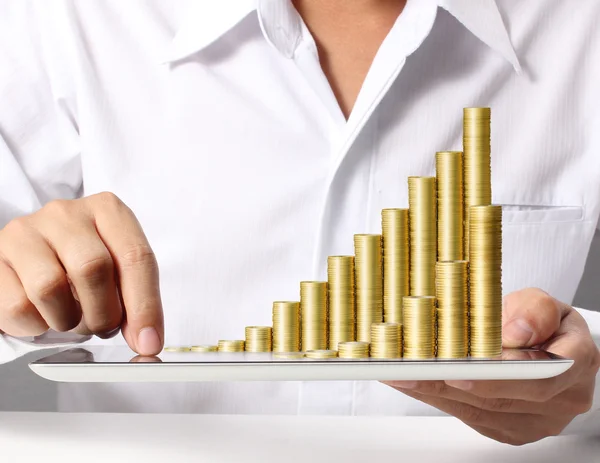 Tablet with the graph ,gold coins — Stock Photo, Image