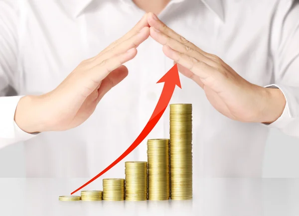 Holding coins graph stock market — Stock Photo, Image