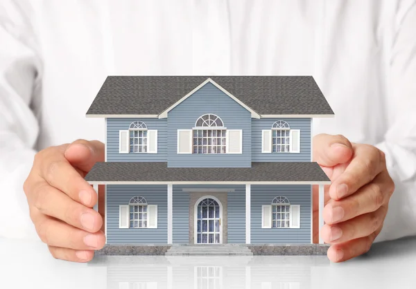 Businessman holding home model — Stock Photo, Image