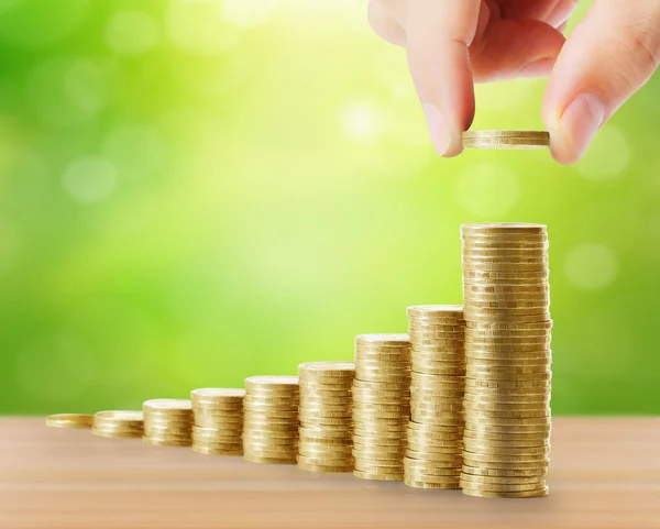 Hand human hand putting coin to money — Stock Photo, Image