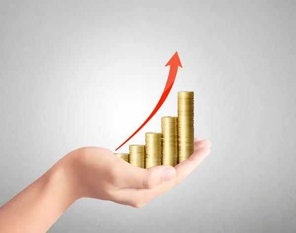 Coins and graph in hand — Stock Photo, Image