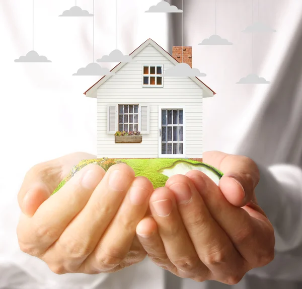 Holding house representing home ownership — Stock Photo, Image