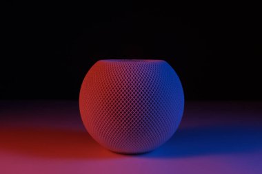 White HomePod mini with orange and blue light clipart