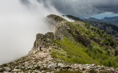 Clouds meet the top of a mountain ridge on GR20 in Corsica clipart