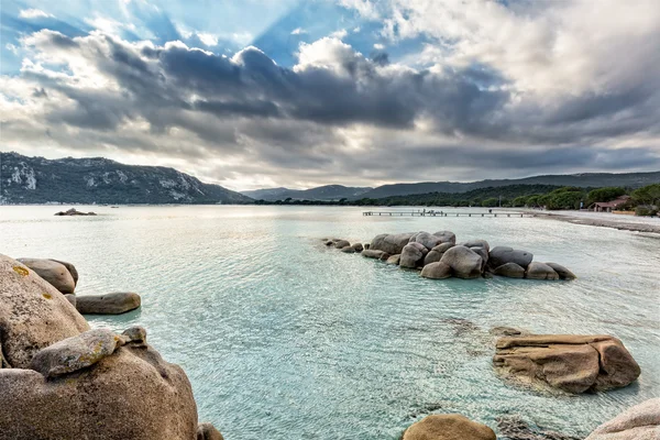 Pedregulhos em mar azul-turquesa na praia de Santa Giulia, na Córsega — Fotografia de Stock