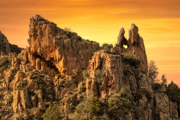 Heart-shaped hole in rock in The Calanches in Corsica at sunset — Stock Photo, Image