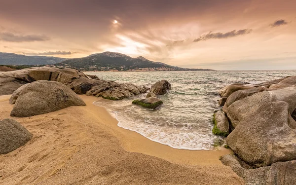 Rocks and sand at Algajola beach in Corsica — Stock Photo, Image