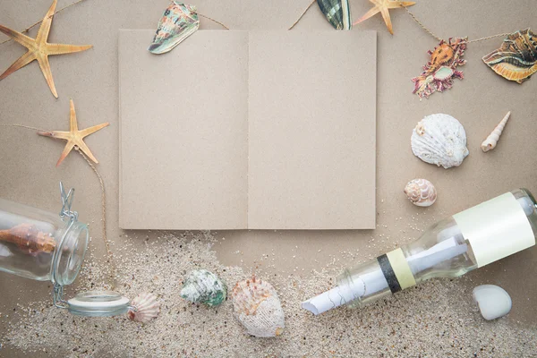 Blank book with sands and letter message in bottle — Stock Photo, Image