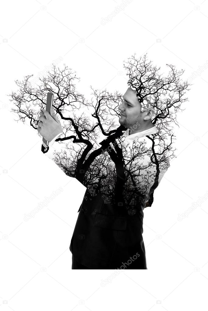 Double exposure portrait of Business man using digital tablet with tree and branch isolated on white