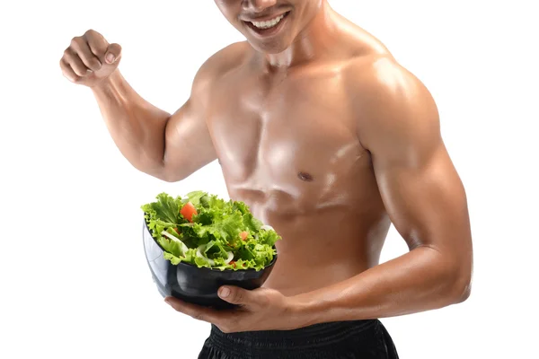 A muscular guy and fresh Salad bowl,shaped abdominal, isolated on white background — Stock Photo, Image