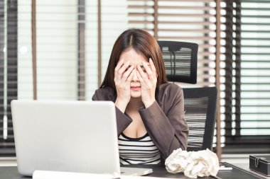 Yorgun genç kadın yönetici ile oturan buruşuk kağıt topları bir