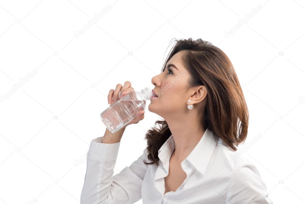 Beautiful business woman drinking water from bottle