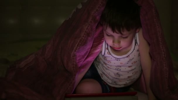 Μικρό αγόρι με δισκίο το βράδυ — Αρχείο Βίντεο