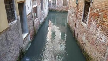 Venedik 'in Sakin Sokakları' nda Hasarlı Alçılı Eski Tuğla Duvarı. Şehirde sel baskını. Yükselen ve düşen su seviyesi. Yollar suyla kaplı. Yapı temelleri, yığının tepesine yerleştirilmiş Istrian kireçtaşı tabakaları üzerine kurulmuştu.. 