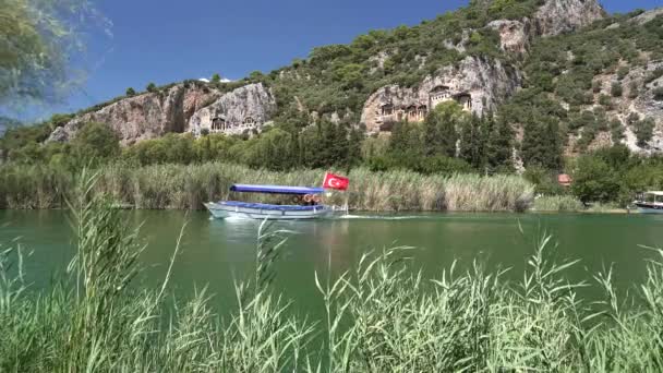 在土耳其的暑假游览船正在芦苇间的一条运河中行驶 旅游观光的暑假渡假河口溪流冰河绿松石斑潜藏有土耳其国旗地中海爱琴海的自然 — 图库视频影像