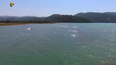 Kiteboard uçurtma ve uçurtma sörfçüleri su üzerinden uçurtma sörfçüleri ile çekilirler. Kiteboardcular uçurtma sörfçüleri, sahil uçurtmacıları, rüzgar sörfçüleri, rüzgar sörfçüleri, folyo folyo, tatilciler, deniz aracı 4K