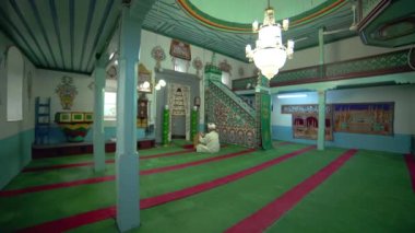 Müslüman cami öğretmeni Kuran 'ı küçük tarihi ahşap bir mescitte okuyor. Cami iç mimari, mistik, dua eden tanrı dini, gizemli dini İslam müslümanı, ibadethane, ibadet yeri, imam salah salaaat ruhani ruhani inanış Suriye.
