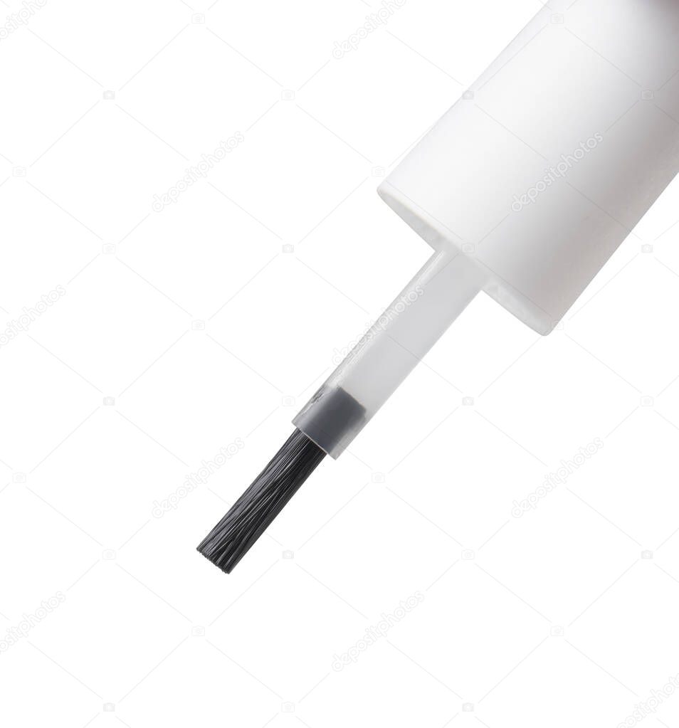 liquid flows down on nail brush on the isolated white background