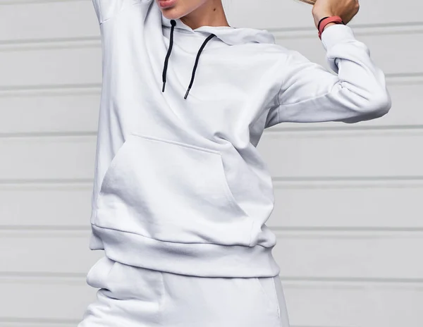 for Girl wears white hoodie and pants. Blonde woman in loose tracksuit with no logo