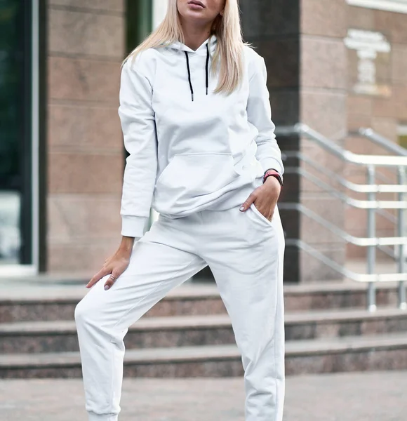 Woman wears white sport wear outfit. Modern girl in the city clothing template