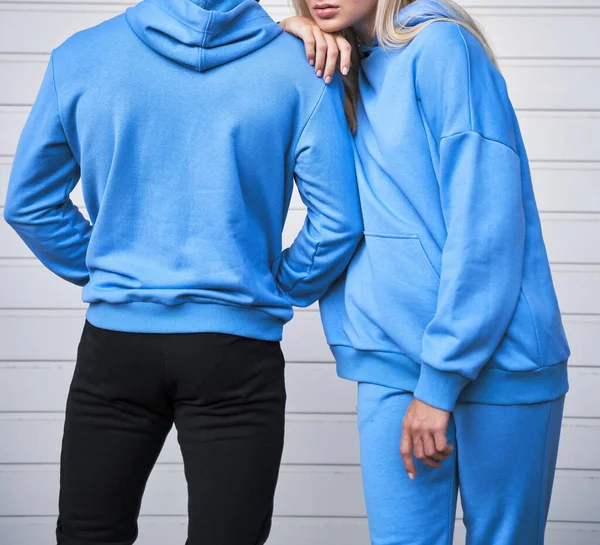 pair of woman and man wear a no logo hoodie. sweatshirt design template. copy space street wear clothing