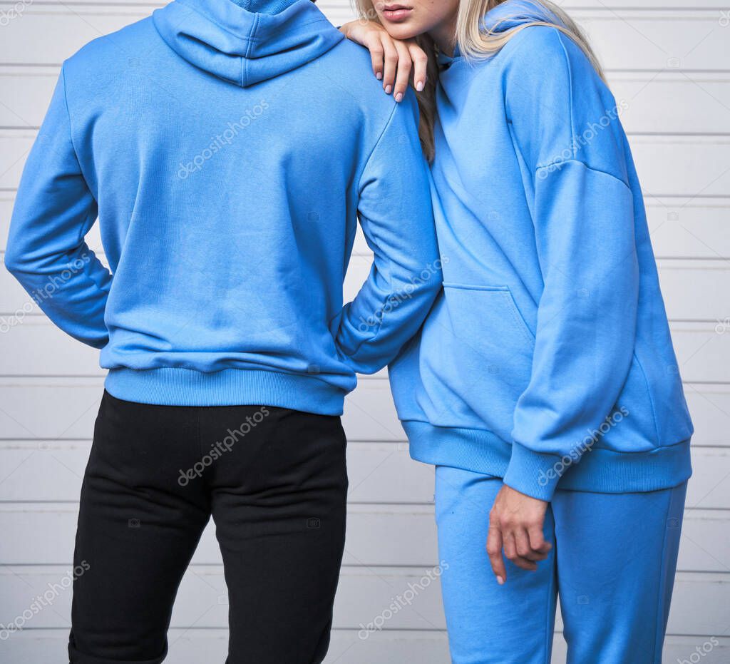 Pair of woman and man wear a no logo hoodie. sweatshirt design template. copy space street wear clothing